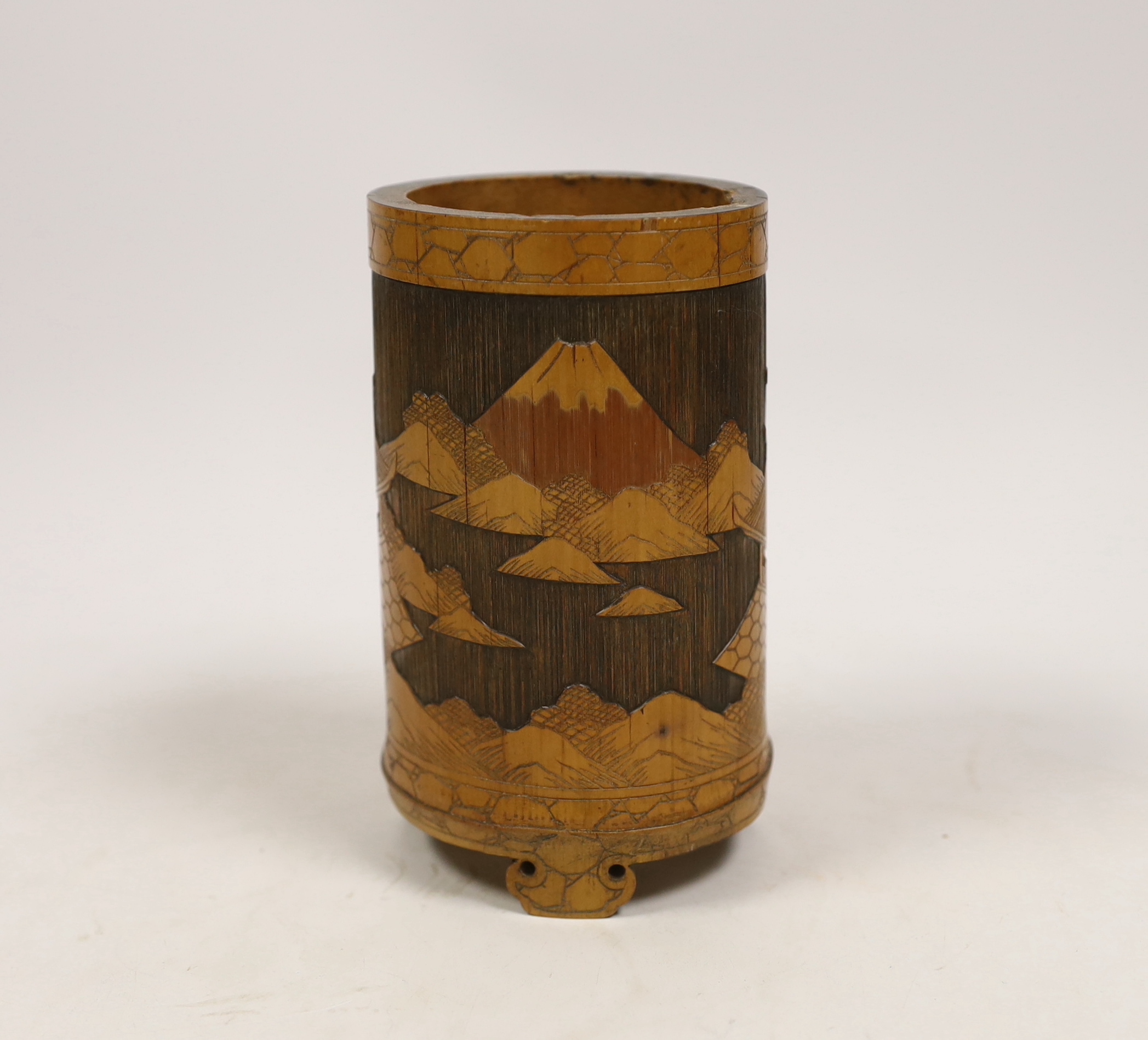 A Japanese bamboo brushpot carved with mountains and pagodas, 13cm high